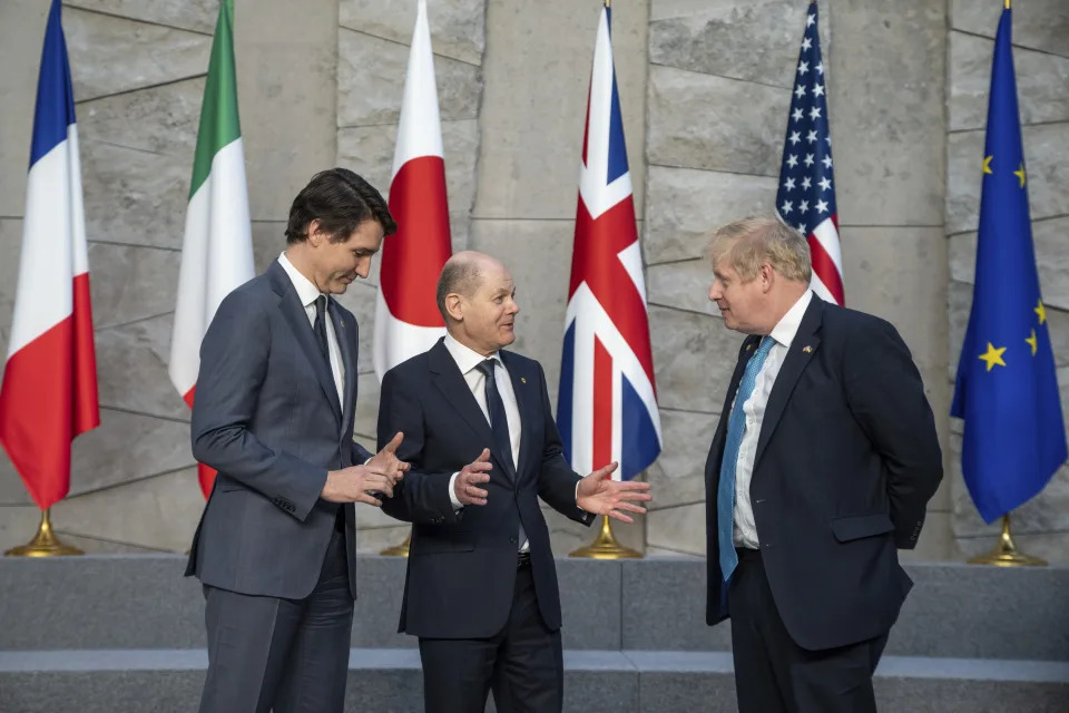 Canadian Prime Minister Justin Trudeau, left, talks with German Chancellor Olaf Scholz, center, and British Prime Minister Boris Johnson, right, during an extraordinary NATO summit at NATO headquarters in Brussels, Belgium, Thursday, March 24, 2022. As the war in Ukraine grinds into a second month, President Joe Biden and Western allies are gathering to chart a path to ramp up pressure on Russian President Vladimir Putin while tending to the economic and security fallout that's spreading across Europe and the world. (Michael Kappeler/DPA via AP, Pool)