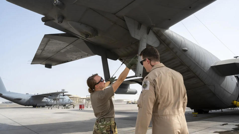 U.S. Air Force Capt. Taylor Drolshagen, 41st Expeditionary Electronic Combat Squadron pilot, shows Maj. Joshua Tempel, 380th Expeditionary Operations Support Squadron, how she conducts her preflight checks on an EC-130H Compass Call aircraft, before participating in a large force employment exercise at Al Dhafra Air Base, United Arab Emirates, July 13, 2021. (Master Sgt. Wolfram M. Stumpf/Air Force)