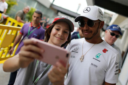 Formula One F1 - Brazilian Grand Prix 2017 - Sao Paulo, Brazil - November 10, 2017. Mercedes' Lewis Hamilton of Britain poses for a selfie after second practice. REUTERS/Ueslei Marcelino