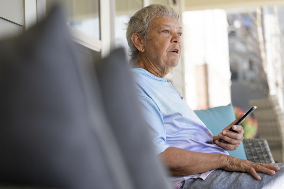 Sheri Wilkins talks about her experience using the DailyPay app outside of the clubhouse at her apartment complex in College Station, Texas on Tuesday, March 26, 2024. (AP Photo/Sam Craft)