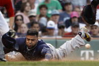 Tampa Bay Rays' Nelson Cruz slides safely home during the 10th inning of a baseball game against the Boston Red Sox, Monday, Sept. 6, 2021, at Fenway Park in Boston. (AP Photo/Winslow Townson)