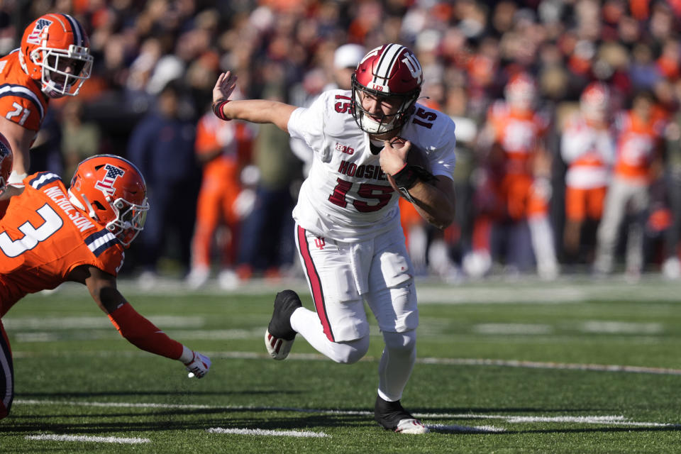 Indiana quarterback Brendan Sorsby turns the corner on Illinois defensive back Tahveon Nicholson and heads to the end zone for a touchdown during the first half of an NCAA college football game Saturday, Nov. 11, 2023, in Champaign, Ill. (AP Photo/Charles Rex Arbogast)