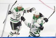 Dallas Stars defenseman Joel Hanley (39) celebrates his goal against the Tampa Bay Lightning with teammates Andrej Sekera (5) and Roope Hintz (24) during first-period NHL Stanley Cup finals hockey action in Edmonton, Alberta, Saturday, Sept. 19, 2020. (Jason Franson/The Canadian Press via AP)