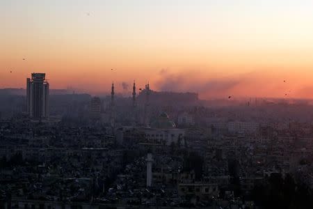 Smoke rises near Aleppo's historic citadel, as seen from a government-controlled area of Aleppo during sunrise, Syria December 6, 2016. REUTERS/Omar Sanadiki