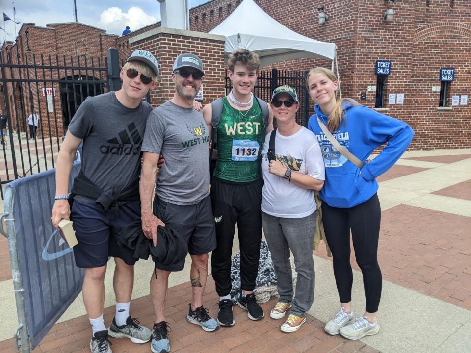 Iowa City West's Aidan Jacobsen, center, with his family, including dad Ryan Jacobsen, right, at the 2023 Drake Relays. Jacobsen is pictured wearing a necklace with his late grandfather Dean Jacobsen's wedding ring attached to it.