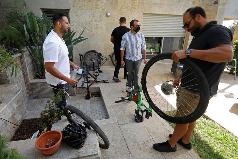 Palestinian cyclists Amer Kurdi and Jerees Rayan inspect their damaged bicycles in Ramallah in the Israeli-occupied West Bank