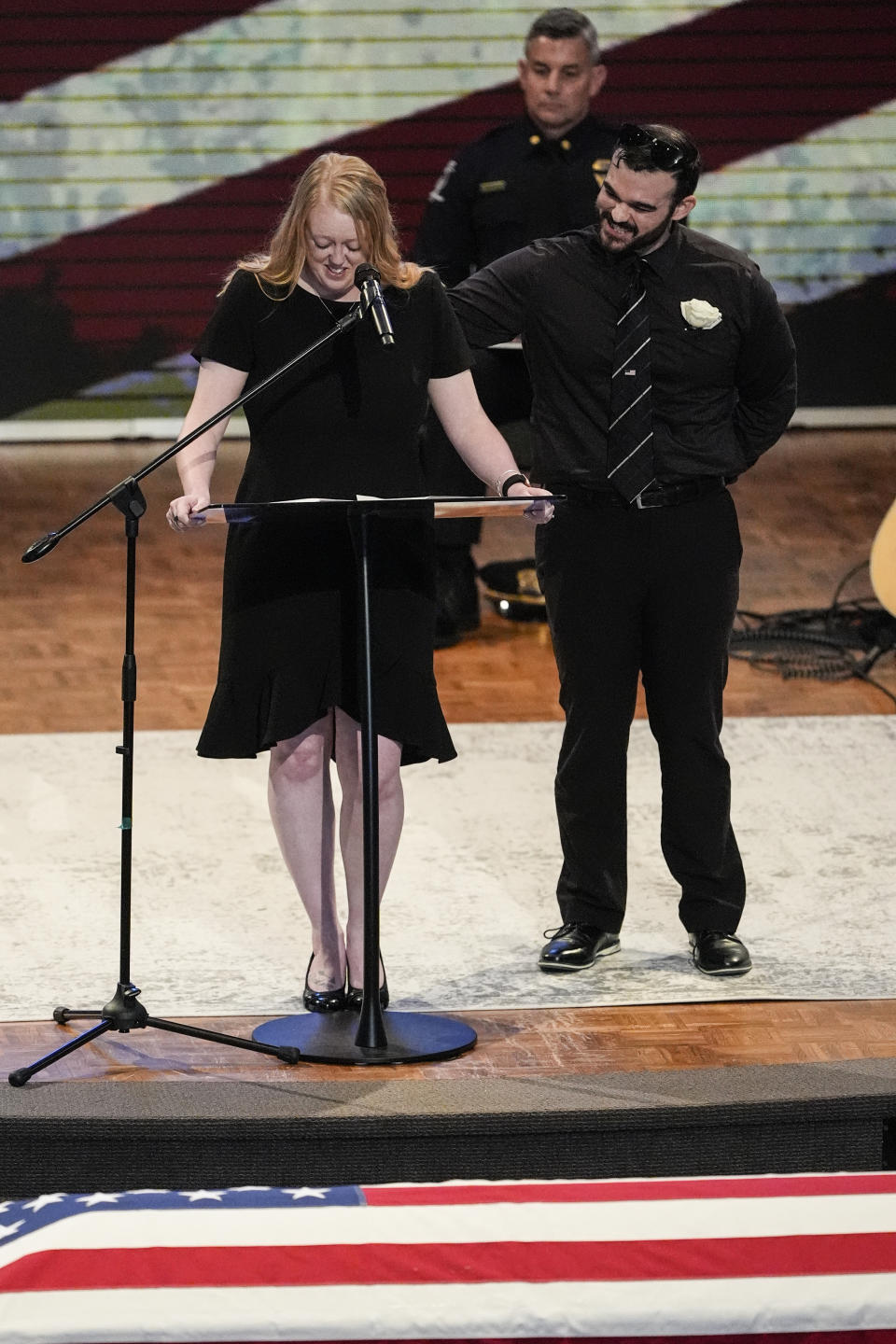 Widow of officer Joshua Eyer, Ashley Eyer speaks during a memorial service for Officer Joshua Eyer, Friday, May 3, 2024, in Charlotte, N.C. Police in North Carolina say a shootout that killed Eyer and wounded and killed other officers began as officers approached a home to serve a felony warrant on Monday. (AP Photo/Chris Carlson)