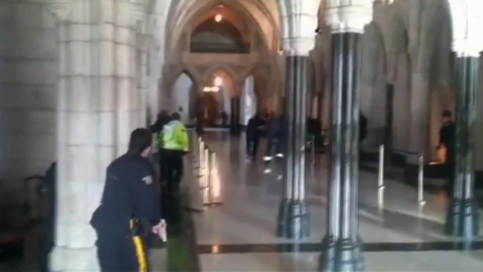 A still image captured from video footage by the Globe and Mail newspaper shows police officers responding to shooting attacks inside the Centre Block of the Parliament buildings in Ottawa, Ontario October 22, 2014. Canadian police are investigating three shooting incidents that took place in Ottawa on Wednesday, one at the Canadian war memorial, one at Parliament Hill, and one near a nearby shopping mall, Ottawa police said. CANADA OUT REUTERS/The Globe and Mail (CANADA - Tags: CRIME LAW CIVIL UNREST POLITICS) NO SALES. NO ARCHIVES. FOR EDITORIAL USE ONLY. NOT FOR SALE FOR MARKETING OR ADVERTISING CAMPAIGNS. MANDATORY CREDIT