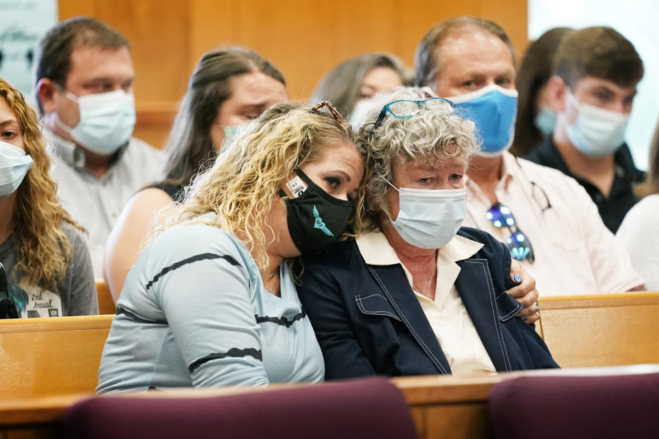 Laura Calderwood, mother of Mollie Tibbetts, right, is comforted as her victim impact statement is read during a sentencing hearing for Cristhian Bahena Rivera, Monday, Aug. 30, 2021, at the Poweshiek County Courthouse in Montezuma, Iowa. Rivera was sentenced to life in prison for the stabbing death of college student Mollie Tibbetts, who was abducted as she was out for a run near her small eastern Iowa hometown in July of 2018. (AP Photo/Charlie Neibergall, pool)