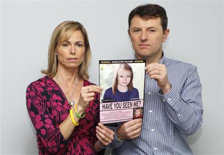 Kate and Gerry McCann are seen posing with a computer generated image of how their missing daughter Madeleine might look, during a news conference in London in this May 2, 2012 file photograph. REUTERS/Andrew Winning/Files