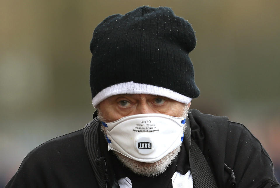 A Newcastle United fan wears a face mask in an attempt to protect himself from the coronavirus, outside the ground prior to the English Premier League soccer match between Southampton and Newcastle United, at St Mary's Stadium, Southampton, England, Saturday March 7, 2020. (Mark Kerton/PA via AP)