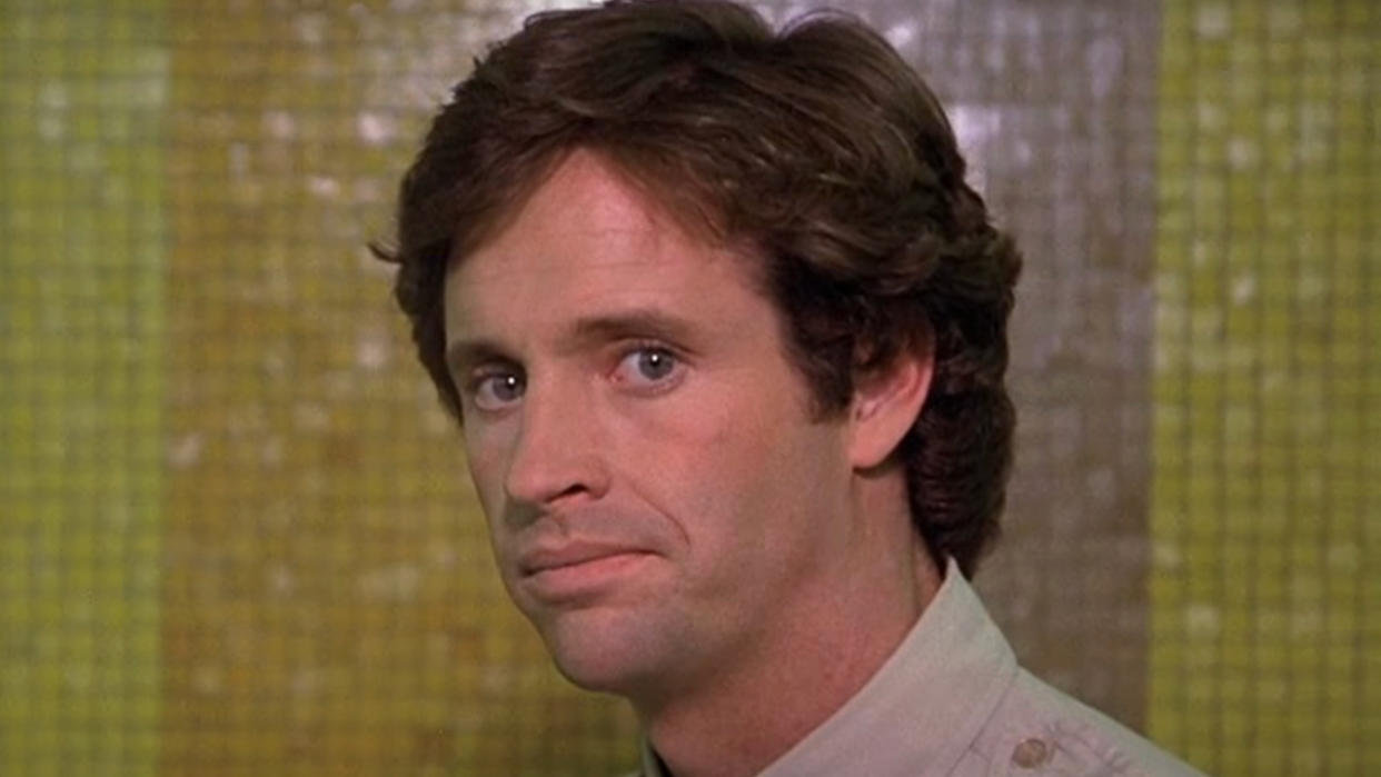  Robert Hays stands with a disappointed expression in Airplane!. 