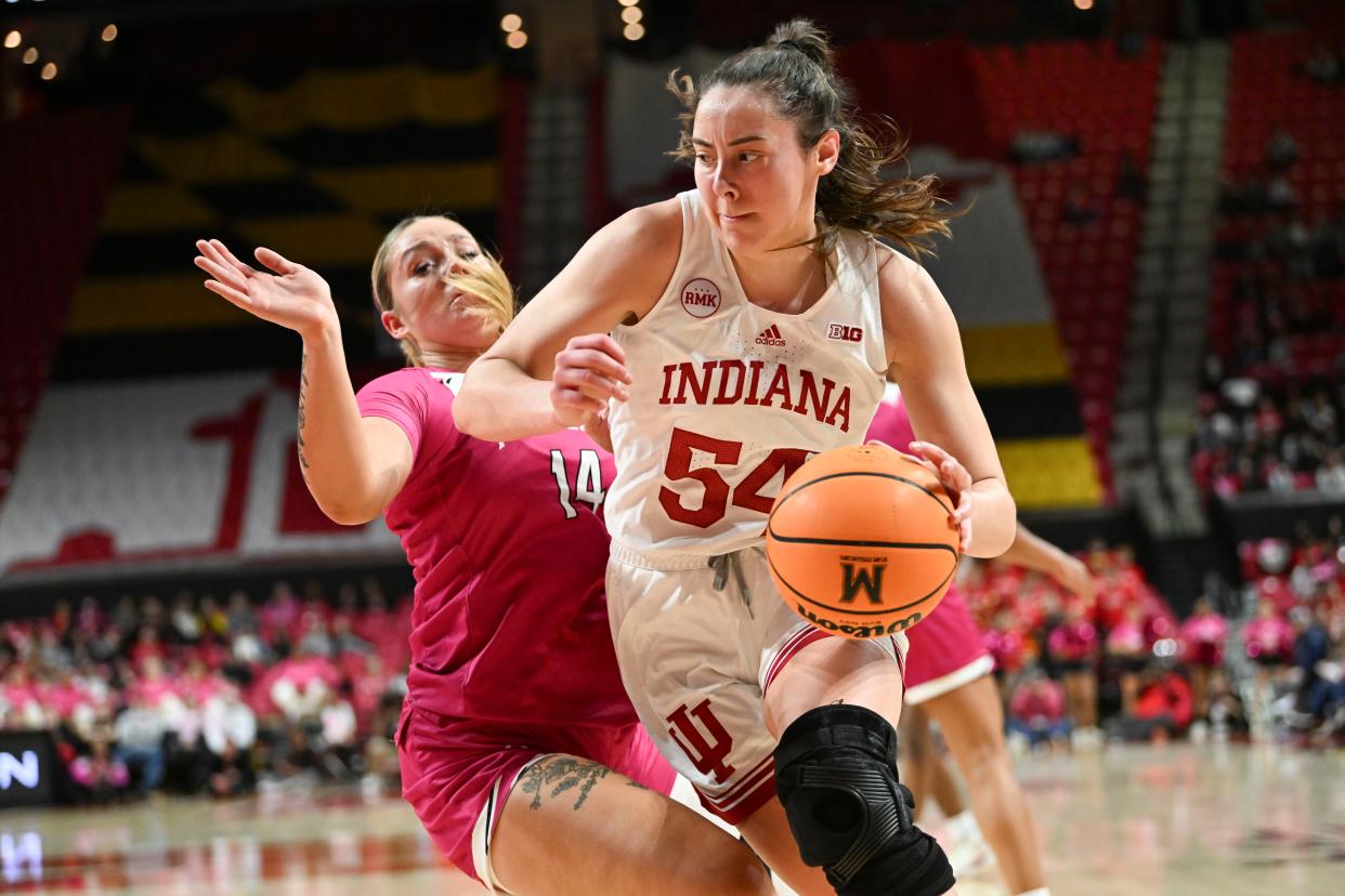 Jan 31, 2024; College Park, Maryland, USA; Indiana Hoosiers forward Mackenzie Holmes (54) makes a moe to the bakst on Maryland Terrapins forward Allie Kubek (14) during the first half 
at Xfinity Center. Mandatory Credit: Tommy Gilligan-USA TODAY Sports