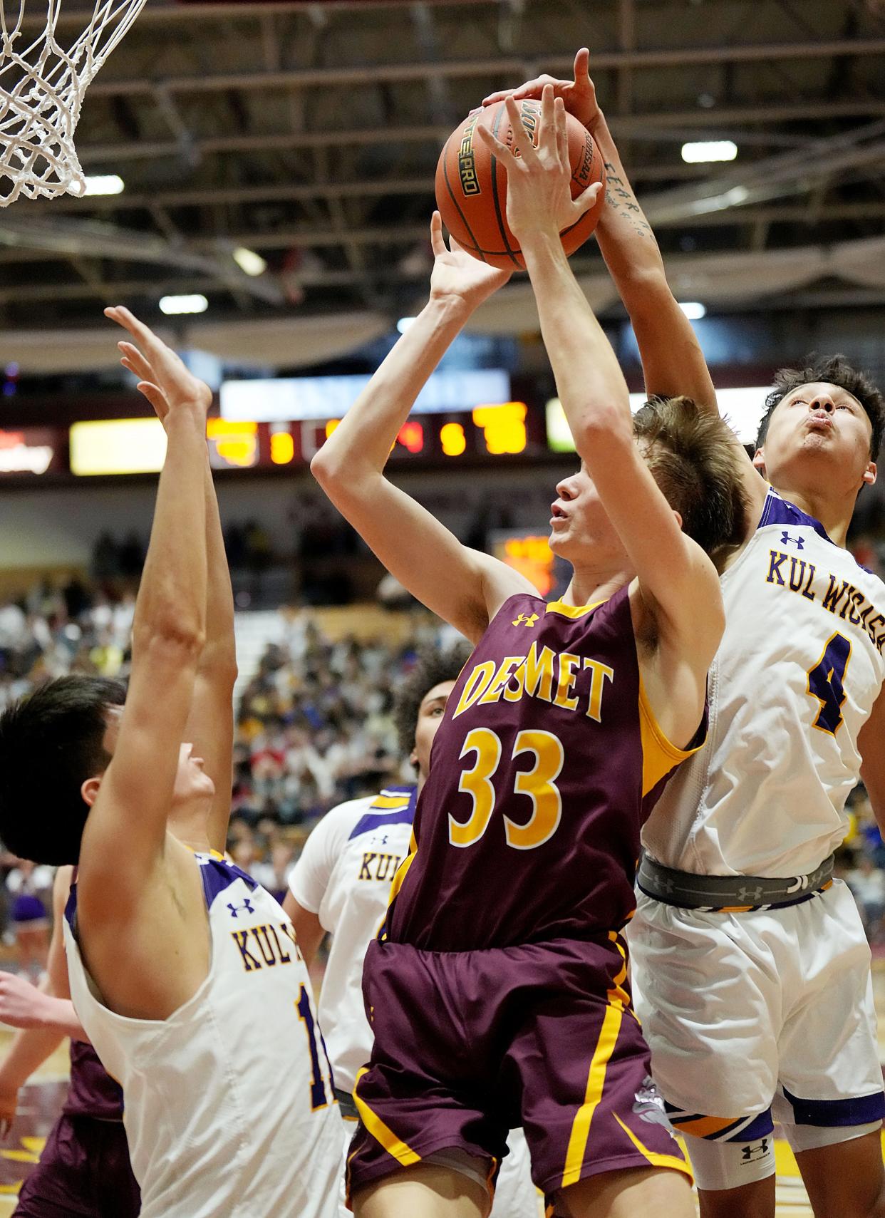 De Smet's George Jensen (33) shoots against Lower Brule's Ellwyn Langdeau and Brian LaRoche Jr. (4) during the championship game of the state Class B boys basketball tournament on Saturday, March 18, 2023 at the Barnett Center in Aberdeen.