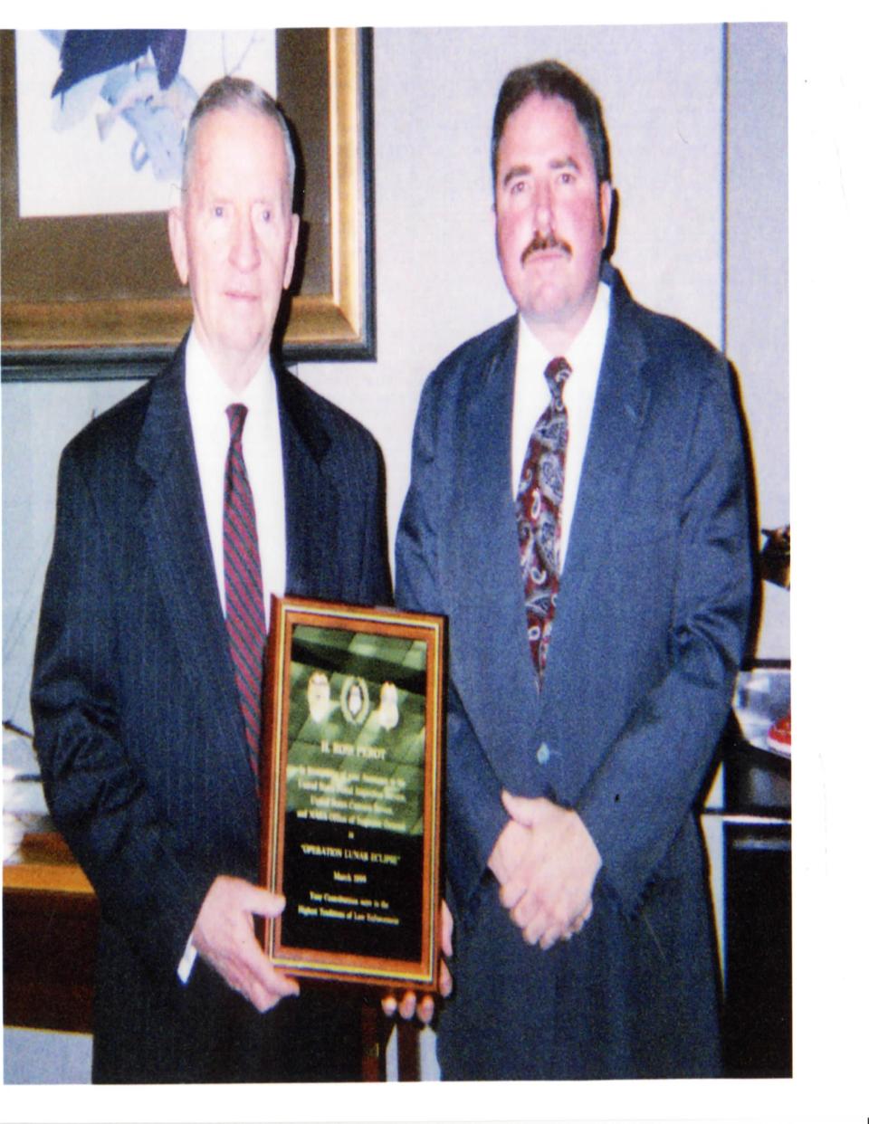 Joseph Gutheinz (right) presenting H. Ross Perot a plaque thanking him with helping NASA's "Operation Lunar Eclipse."