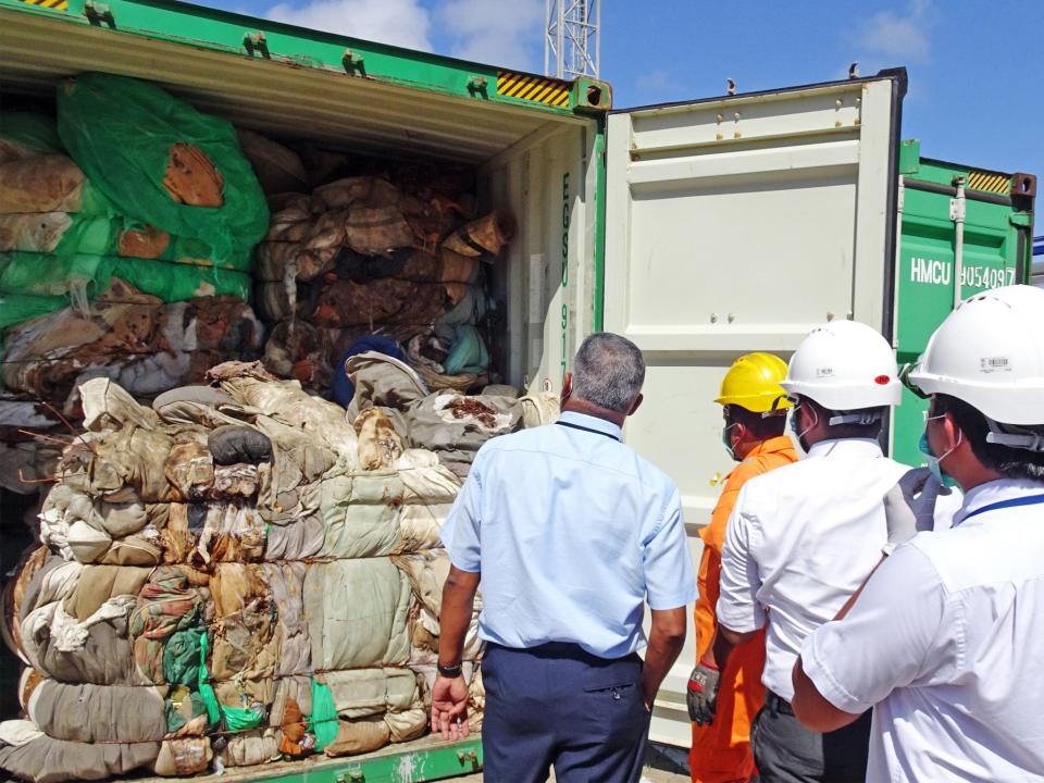 Customs officials inspect container at Colombo port in 2019 following similar incident of hazardous clinical waste entering the country (AFP/Getty Images)