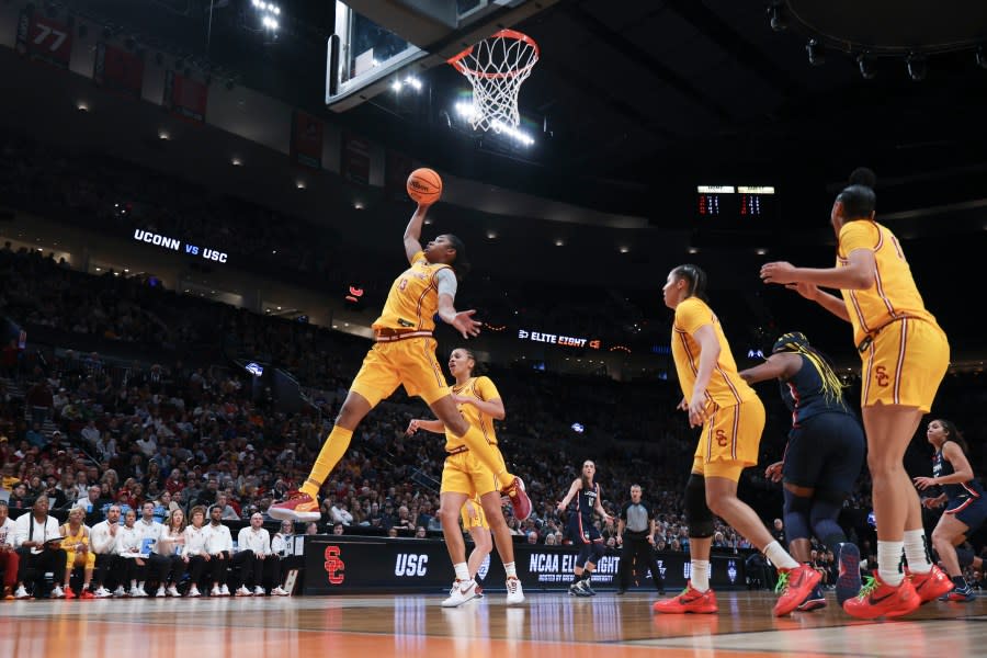 Southern California center Rayah Marshall (13) grab a rebound during the first half of an Elite Eight college basketball game against UConn in the women’s NCAA Tournament, Monday, April 1, 2024, in Portland, Ore. (AP Photo/Howard Lao)