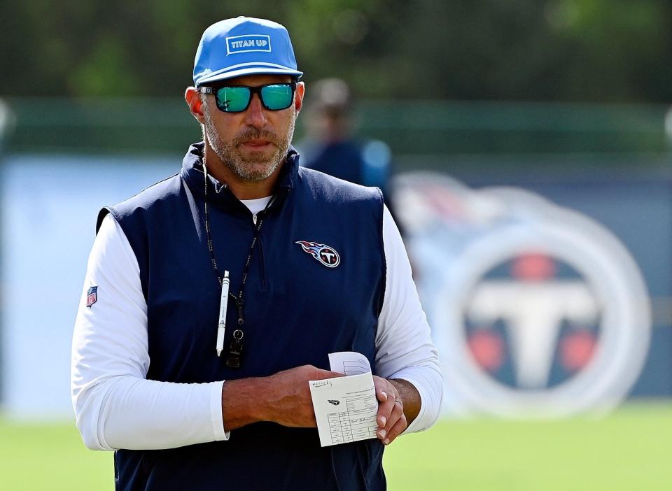 Tennessee Titans coach Mike Vrabel watches players warm up during a 2023 training camp practice in Nashville, Tenn.