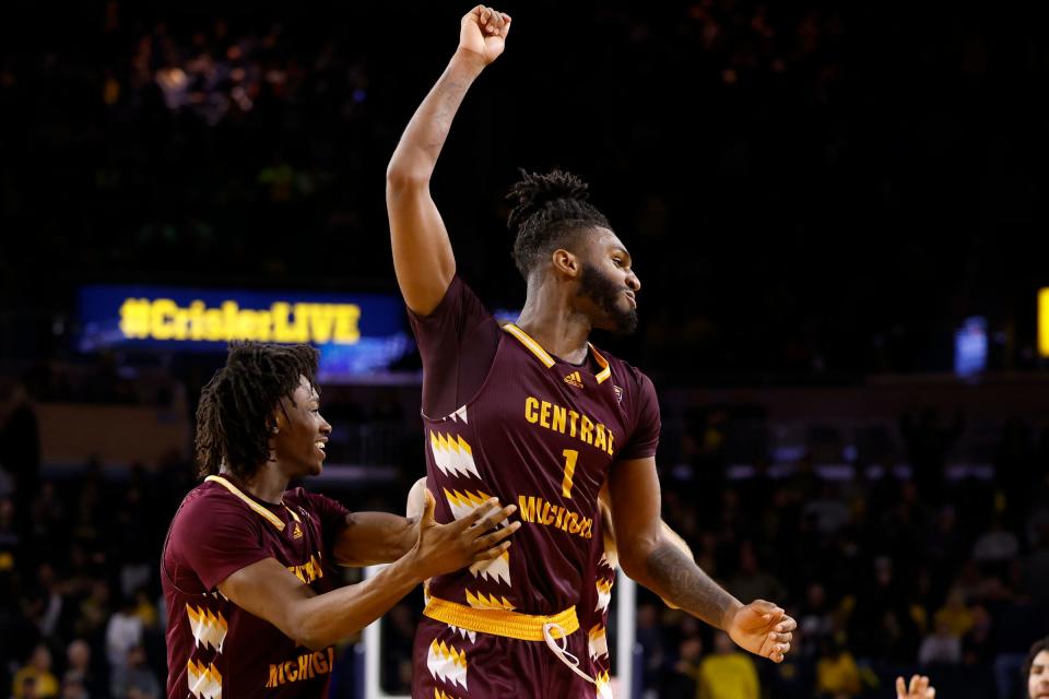 Central Michigan forward Ola Ajiboye, left, and guard Reggie Bass celebrate after U-M's 63-61 loss to CMU on Thursday, Dec. 29, 2022, at Crisler Center.