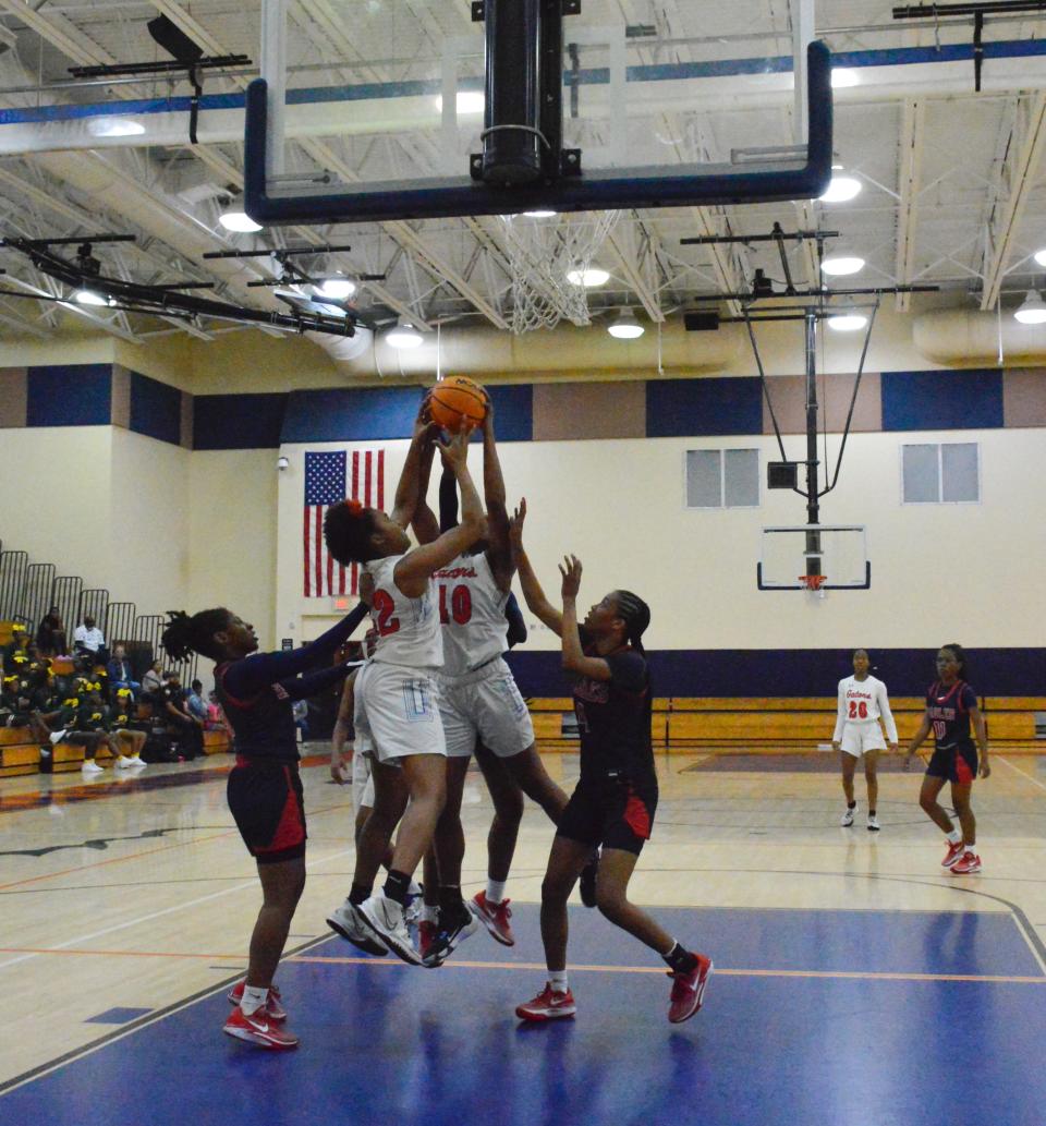 Palm Beach Gardens defender Kyana Poitier jumps to block against Centennial on Feb. 9, 2024.