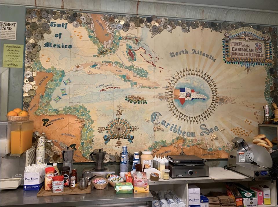 The film’s scenic department created a historic map of the Dominican Republic for the bodega. Coates also designed a painted mural on the side of the market with an image of a man in a boat dreaming of the day he returns to the island.