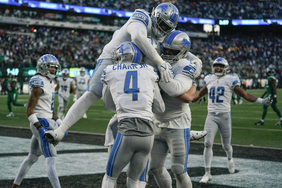 The Detroit Lions celebrate a touchdown by tight end Brock Wright (89) against the New York Jets during the fourth quarter of an NFL football game, Sunday, Dec. 18, 2022, in East Rutherford, N.J. (AP Photo/Seth Wenig)