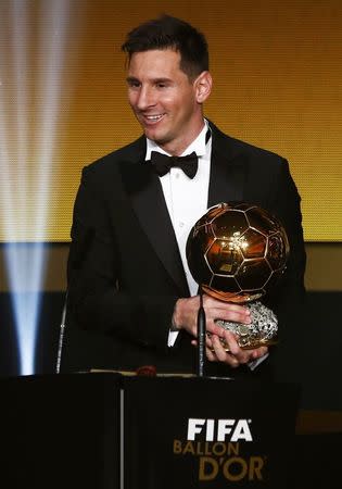 FC Barcelona's Lionel Messi of Argentina holds the FIFA Ballon d'Or 2015 award for the world player of the year at a ceremony in Zurich, Switzerland, January 11, 2016. REUTERS/Arnd Wiegmann