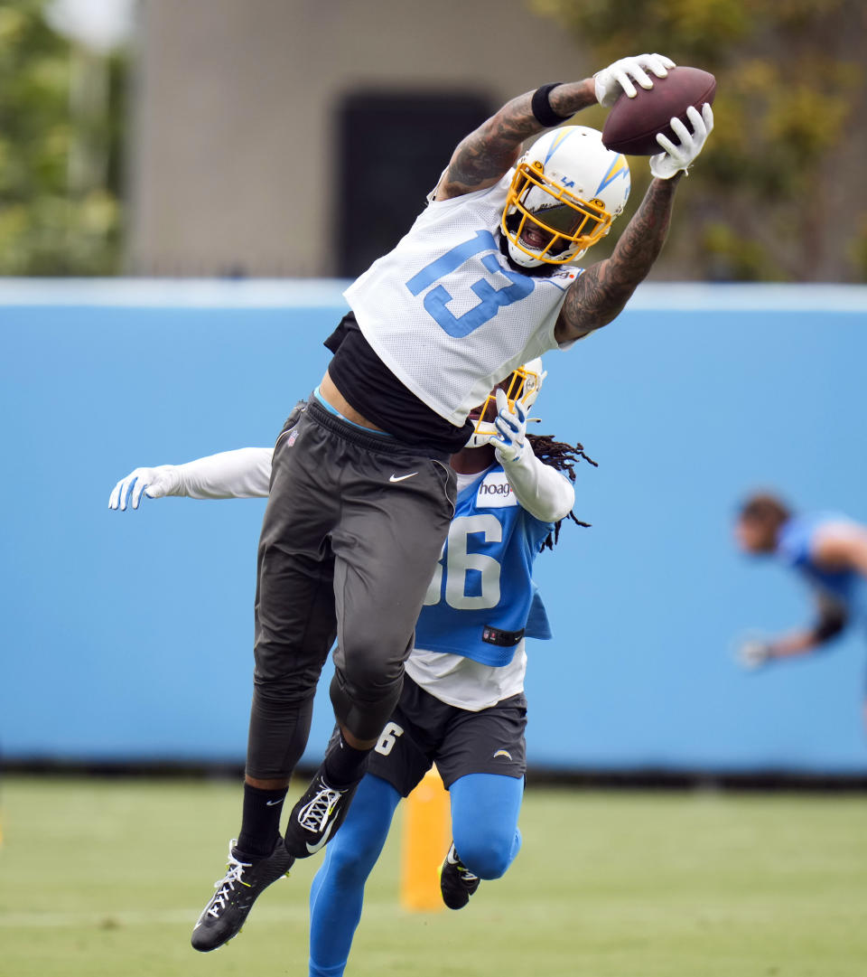 Los Angeles Chargers wide receiver Keenan Allen (13) makes a catch against Ja'Sir Taylor (36) during the NFL football team's camp Wednesday, May 31, 2023, in Costa Mesa, Calif. (AP Photo/Jae C. Hong)