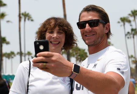 Jul 23, 2016; Los Angeles, CA, USA; American water polo player Tony Azevedo (right) takes a selfie with Melanie Murez (left) during the Team USA Road to Rio tour at Venice Beach. Mandatory Credit: Kelvin Kuo-USA TODAY Sports