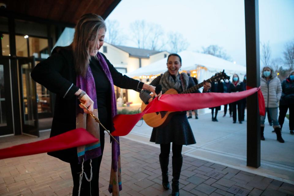 Senior Rabbi Sharon Mars, left, cuts the ribbon while cantor Bat-Ami Moses smiles during the grand opening of Temple Israel on East Broad Street in the Eastmoor neighborhood on the last day of Hanukkah.