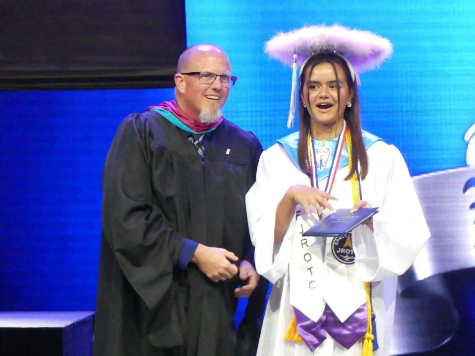 Principal Chet Richards congratulates a senior during the Academy for Academic Excellence annual commencement ceremony on Friday, June 9, 2023 at High Desert Church in Victorville.