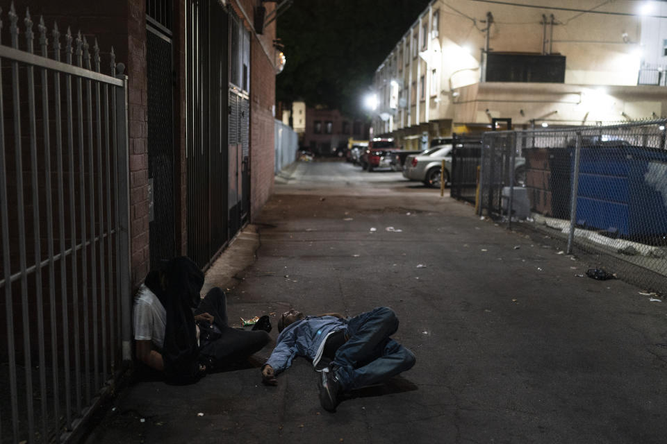 Two addicts sleep in an alley in Los Angeles, Wednesday, Sept. 21, 2022. Nearly 2,000 homeless people died in the city from April 2020 to March 2021, a 56% increase from the previous year, according to a report released by the Los Angeles County Department of Public Health. Overdose was the leading cause of death, killing more than 700. (AP Photo/Jae C. Hong)