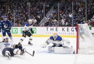 St. Louis Blues goalie Jake Allen, right, allows a second goal to Vancouver Canucks' J.T. Miller during the second period of an NHL hockey game in Vancouver, British Columbia on Monday Jan. 27, 2020. (Darryl Dyck/The Canadian Press via AP)