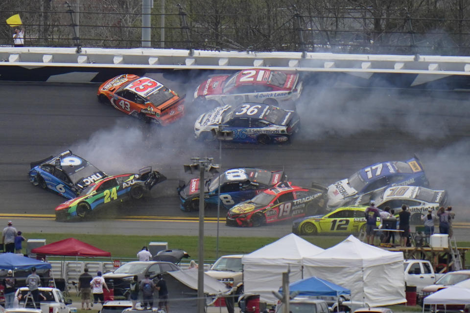 CORRECTS TO 14TH LAP, NOT 13TH AS ORIGINALLY SENT - Cars collide on the 14th lap during the NASCAR Daytona 500 auto race at Daytona International Speedway, Sunday, Feb. 14, 2021, in Daytona Beach, Fla. (AP Photo/Chris O'Meara)