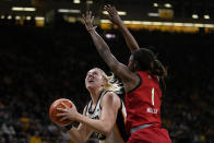 Iowa forward Monika Czinano, left, drives to the basket past Maryland guard Diamond Miller (1) during the second half of an NCAA college basketball game, Thursday, Feb. 2, 2023, in Iowa City, Iowa. Iowa won 96-82. (AP Photo/Charlie Neibergall)