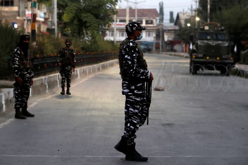 Indian security force personnel stand guard near the residence of Syed Ali Shah Geelani after his death in Srinagar