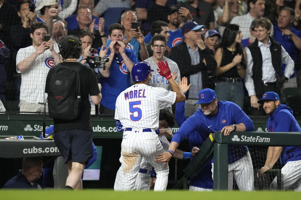 Chicago Cubs' Christopher Morel is greeted at the dugout by manager David Ross, right, after Morel's home run off New York Mets relief pitcher Stephen Nogosek during the seventh inning of a baseball game Tuesday, May 23, 2023, in Chicago. (AP Photo/Charles Rex Arbogast)