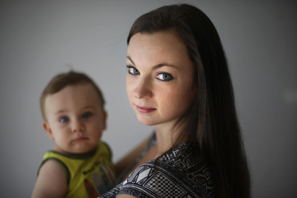 In this Aug. 23, 2012, photo, social worker Shannon Coyne poses for a portrait with her 11-month-old son in Philadelphia. Coyne and her husband decided against circumcision for their son. The nation's most influential pediatricians group says the health benefits of circumcision in newborn boys outweigh any risks and insurance companies should pay for it. In its latest policy statement on circumcision, a procedure that has been declining nationwide, the American Academy of Pediatrics moves closer to an endorsement but says the decision should be up to parents. (AP Photo/Matt Rourke)