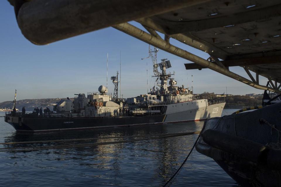 People stand aboard the Ukrainian navy corvette Ternopil vessel as it stands at harbor in Sevastopol, Ukraine, Monday, March 3, 2014. The Ukrainian Defense Ministry said that Russian forces that have overtaken Ukraine's strategic region of Crimea are demanding that the ship's crew surrender. (AP Photo/Andrew Lubimov)