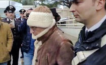 In this picture taken from a video released by Italian Carabinieri on Monday, Jan. 16, 2023, top Mafia boss Matteo Messina Denaro, center, leaves an Italian Carabinieri barrack soon after his arrest at a private clinic in Palermo, Sicily, after 30 years on the run, Monday, Jan. 16, 2023. (Carabinieri via AP)
