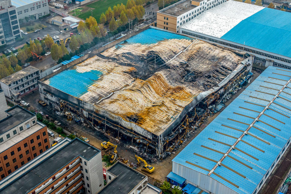 In this aerial photo, a building at the center of a deadly fire is seen in Anyang in central China's Henan Province, Tuesday, Nov. 22, 2022. Investigators said that sparks from welding work appears to have been the cause of a fire that killed several dozen people at a company dealing in chemicals and other industrial goods in central China's Henan province. (Chinatopix via AP)