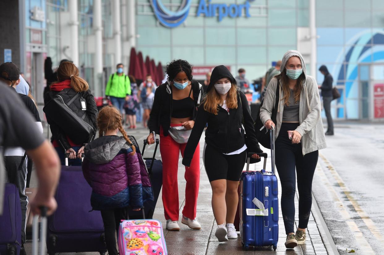Passengers arriving at Birmingham Airport as many people arrive into England from holidays in Spain: PA