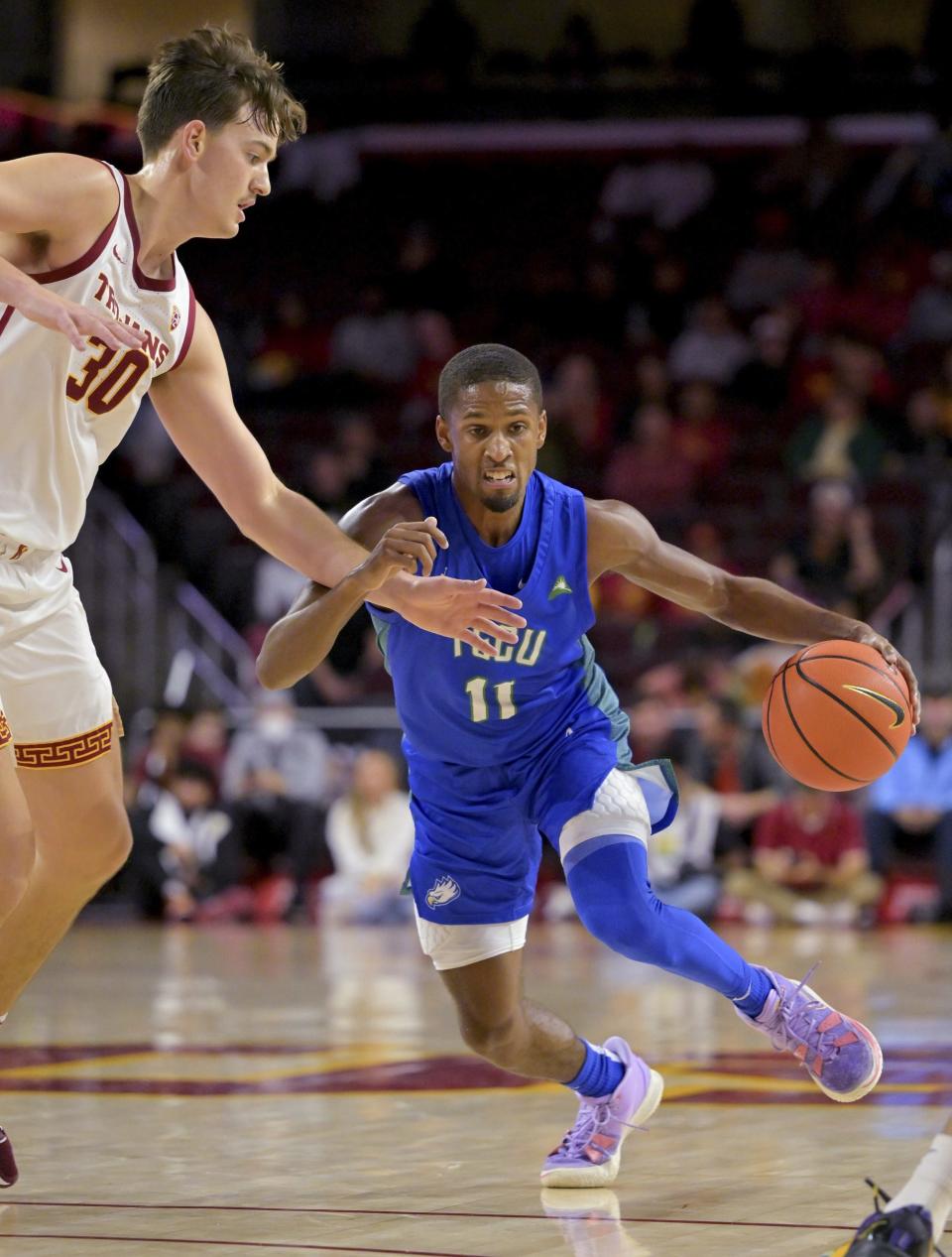 Florida Gulf Coast Eagles guard Isaiah Thompson (11) is defended by USC Trojans forward Harrison Hornery (30) as he drives to the basket in the second half at Galen Center.