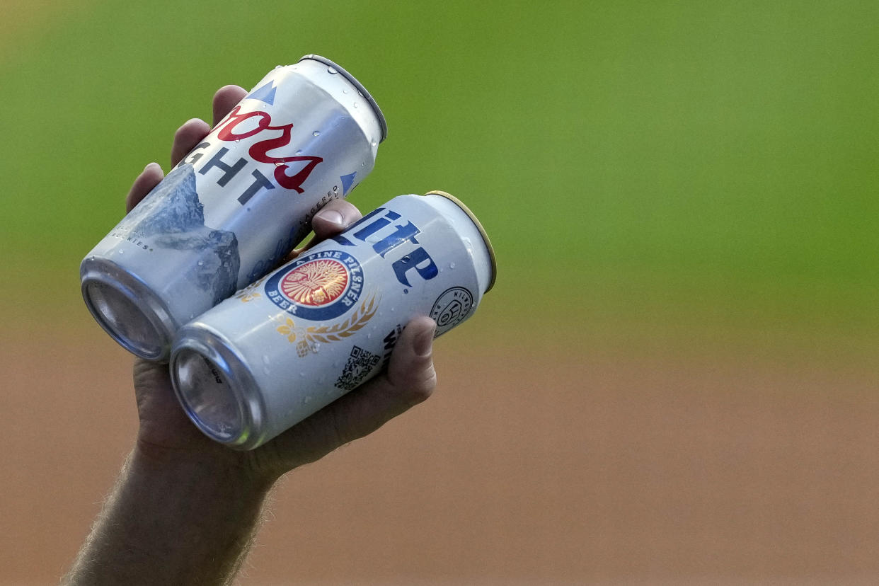 MILWAUKEE, WISCONSIN - JUNE 24: A beer vendor holds Coors Light and Miller Lite beer cans during a game between the Toronto Blue Jays and Milwaukee Brewers at American Family Field on June 24, 2022 in Milwaukee, Wisconsin. (Photo by Patrick McDermott/Getty Images)