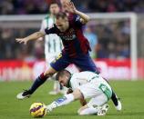 Barcelona's player Andres Iniesta (top) fights for the ball against Cordoba's Fede Cartabia during their Spanish First division soccer match at Camp Nou stadium in Barcelona December 20, 2014. REUTERS/Albert Gea