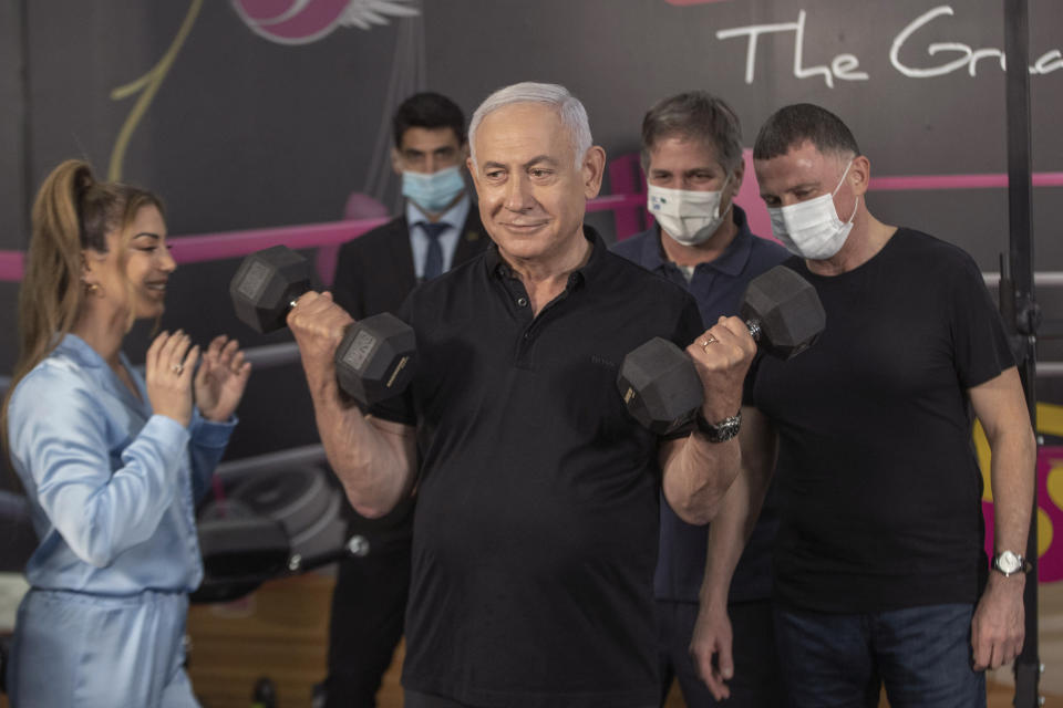 Israeli Prime Minister Benjamin Netanyahu and Health Minister Yuli Edelstein visits Fitness gym ahead of the re-opening of the branch in Petah Tikva, Israel on Saturday, Feb. 20, 2021. (AP Photo/Tal Shahar, Yediot Ahronot, Pool)