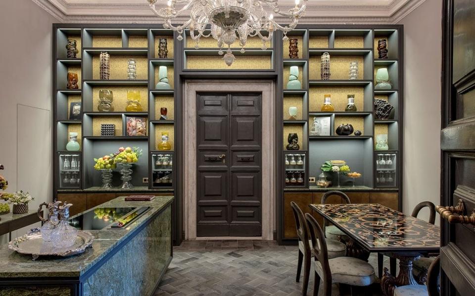 decadent kitchen and dining room, with shelves full of ornaments and chandelier - Giovanni De Sandre 