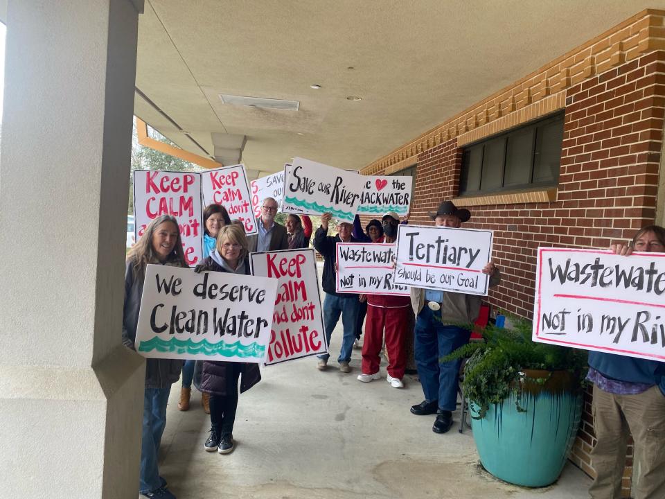 Milton residents gather Friday outside City Hall to protest the new wastewater treatment facility.
