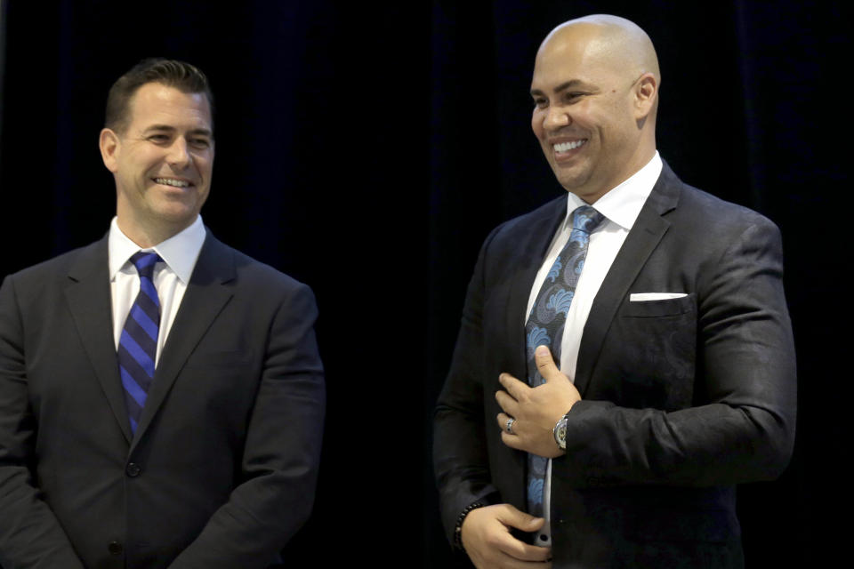 FILE - In this Nov. 4, 2019, file photo, New York Mets new manager, Carlos Beltran, right, laughs with general manager Brodie Van Wagenen at the start of an introductory baseball news conference at Citi Field in New York. Beltran is out as manager of the Mets. The team announced the move Thursday, Jan. 16, 2020. (AP Photo/Seth Wenig, File)