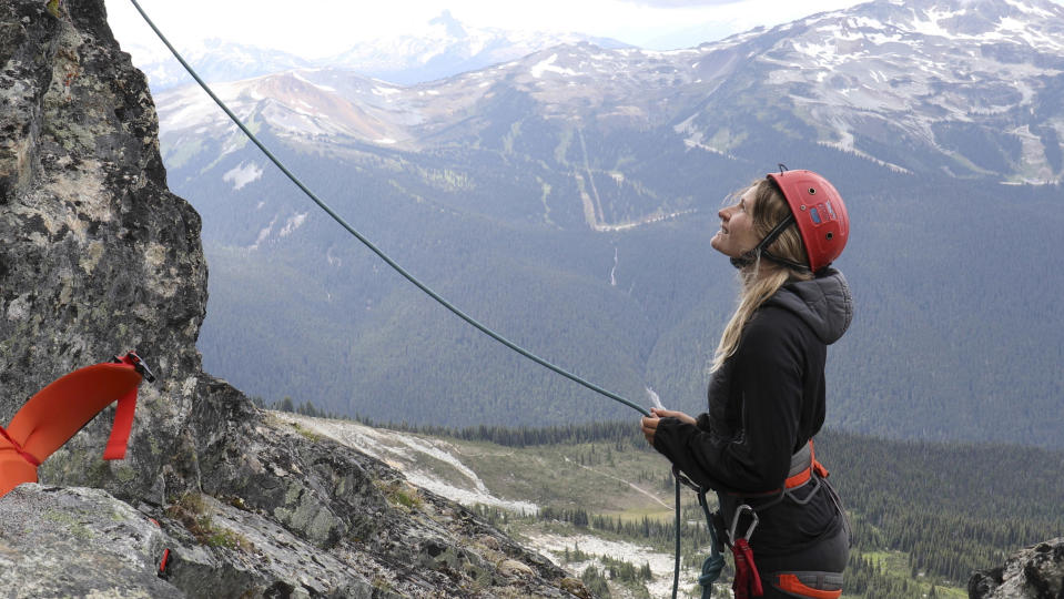 how to belay: belayer at the bottom of a climb